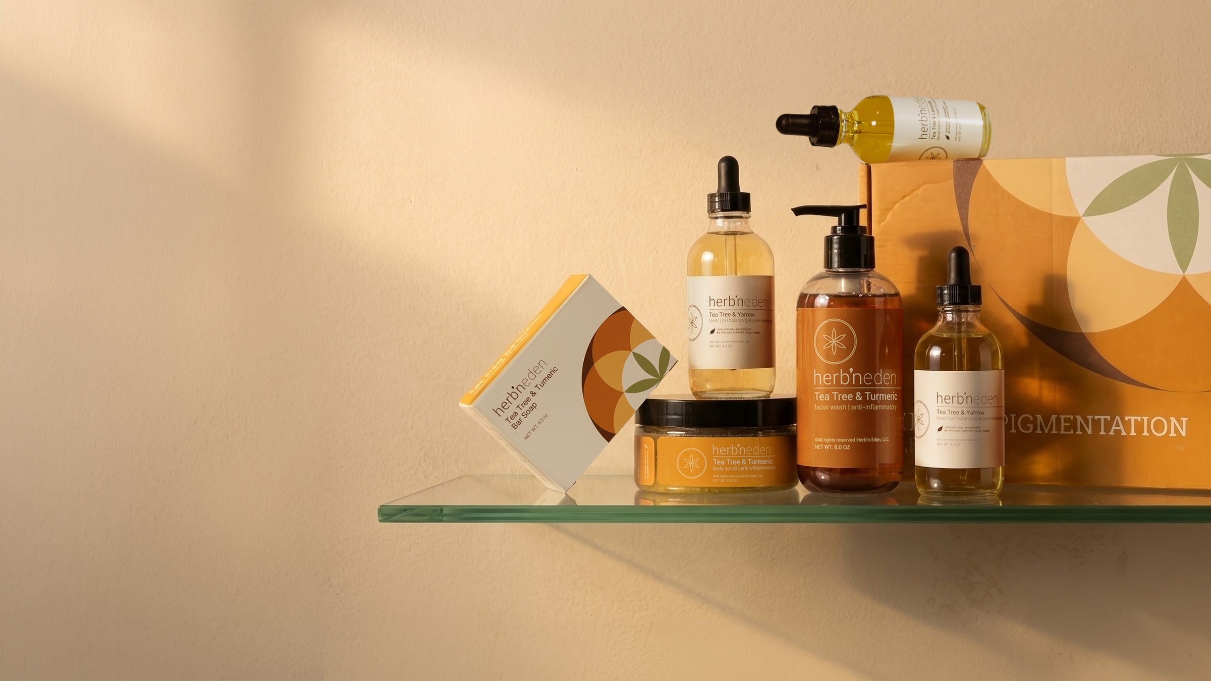 Collection of skincare products for hyperpigmentation on a glass shelf with a warm beige background
