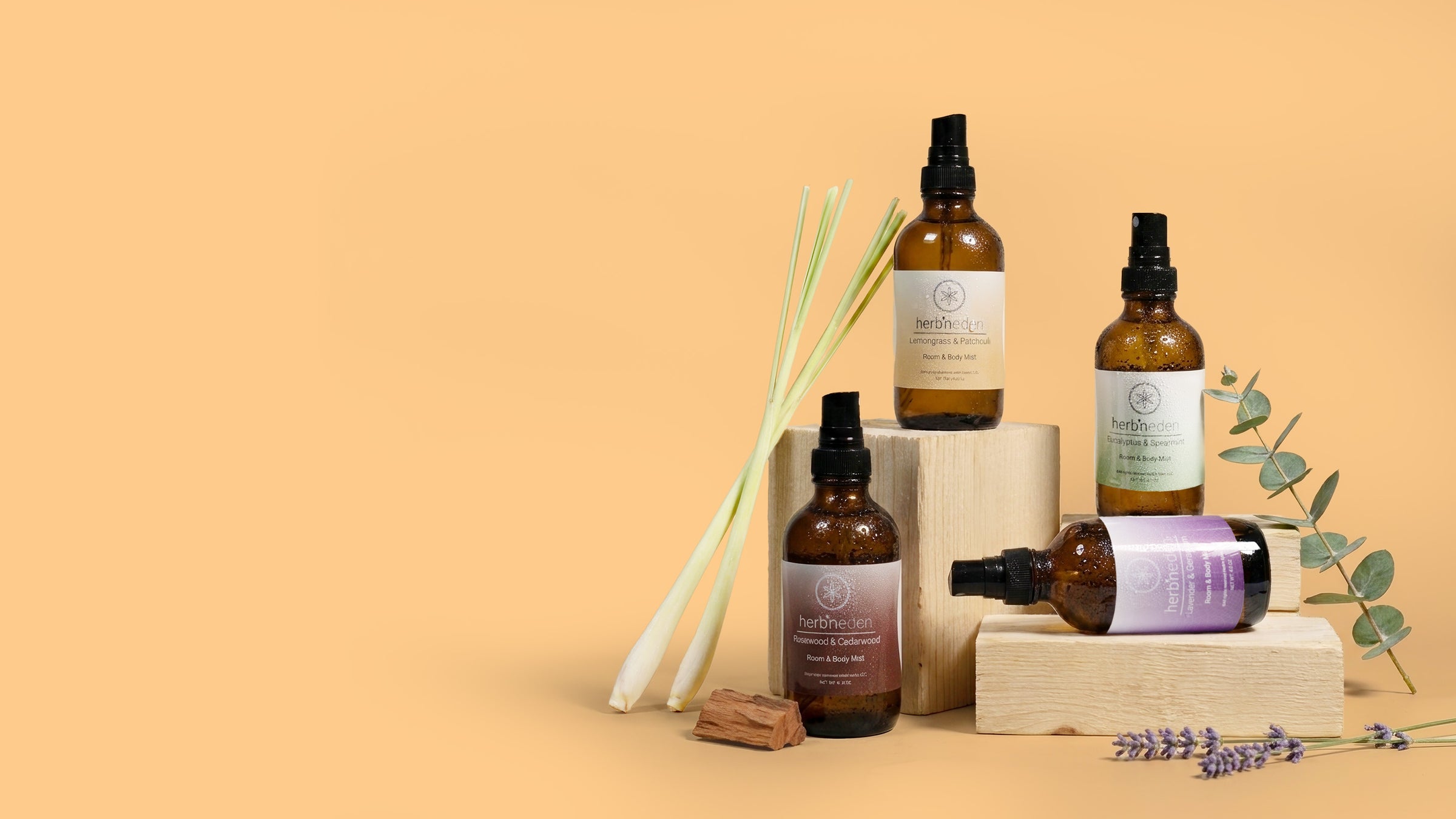collection of four mists scattered on neutral colored blocks and ingredients